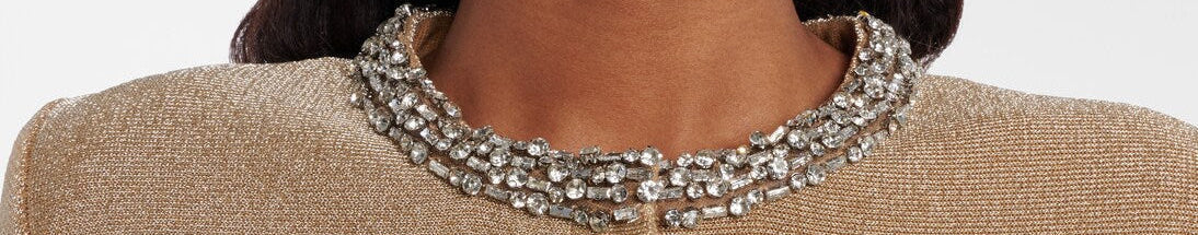 Close-up of a beige textured jacket with decorative buttons and a woman wearing it.
